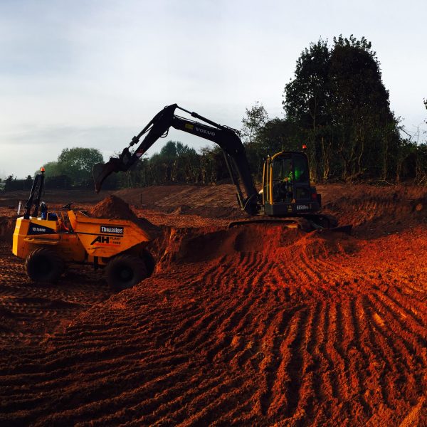 clearance contractors uk yellow digger on top dirt mound